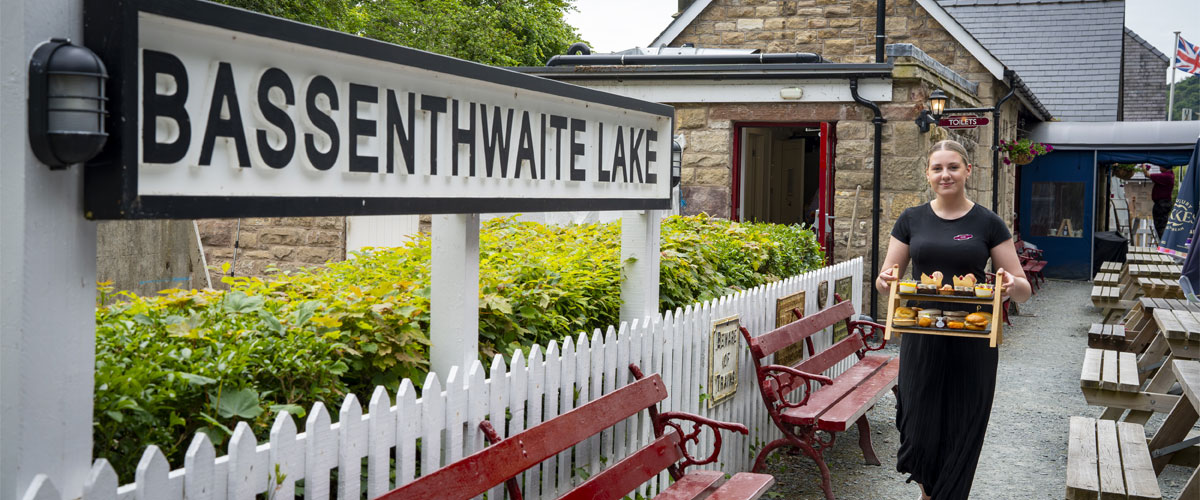 Server carries an afternoon tea spread to the carriage at Bassenthwaite Lake Station