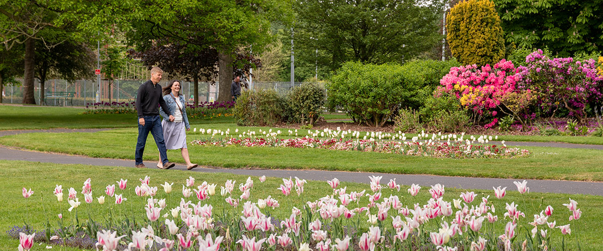 A couple walking in Bitts Park, Carlisle