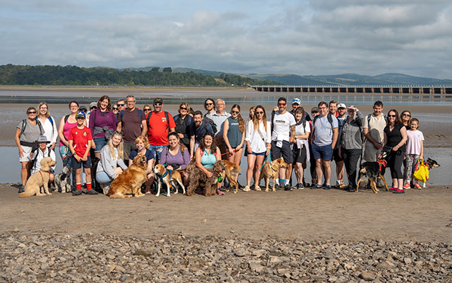 Members of the Cumbria Tourism team (and their dogs) embark on the Cross Bay Walk