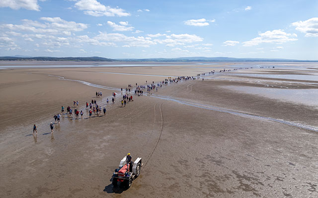 The cross-bay walk group makes its way across the sands of Morecambe Bay